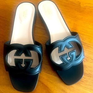Gucci black cutout leather slides